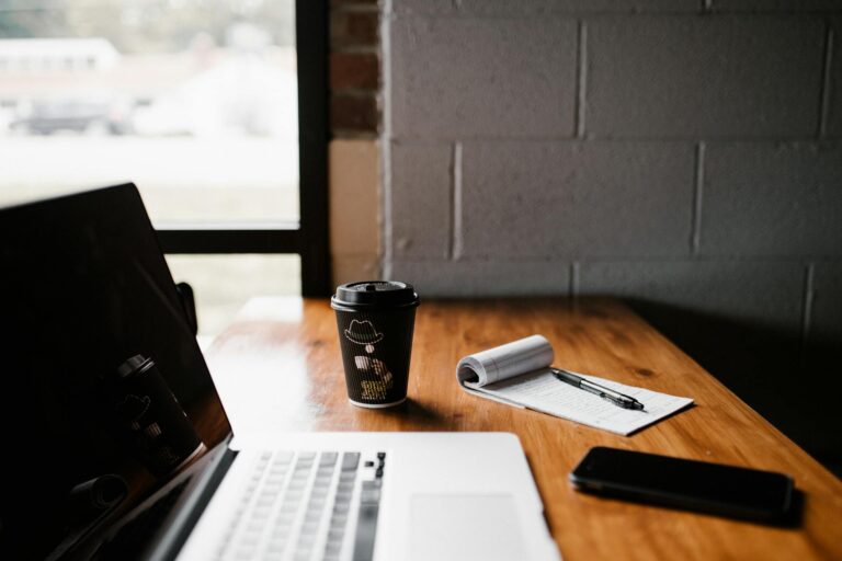 A quiet desk by a window in morning light