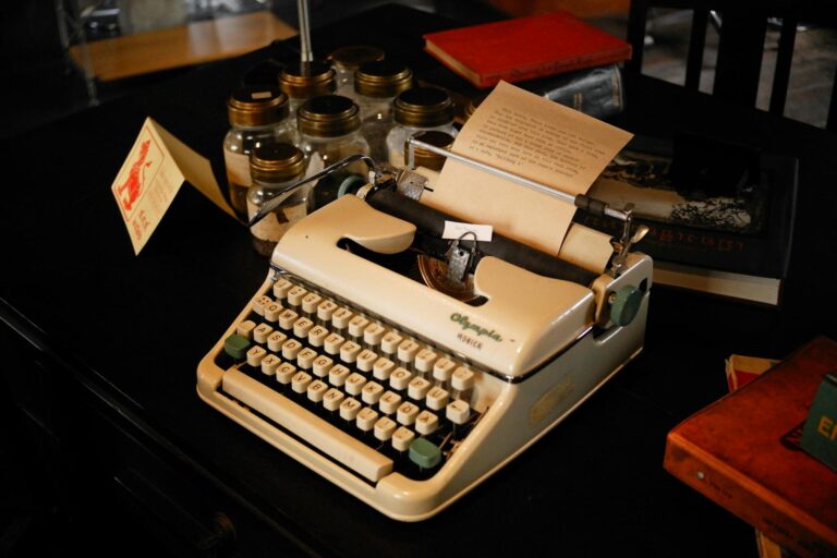 An antique typewriter with a fresh sheet of paper