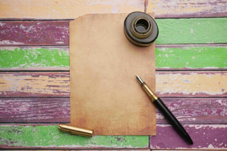 A fountain pen writing on cream paper