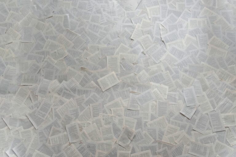 Scattered pages of a manuscript on a desk